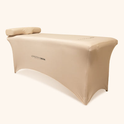 a lash bed with a beige bed cover