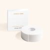 a roll of microfoam tape for eyelash extensions beside its box