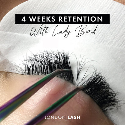 a close up of a set of lash extensions showing the retention with lady bond after 4 weeks. One lash has been isolated to show that the fan is still attached and has grown out