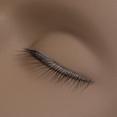 a close up of the lashes on a mannequin training head for lash extensions