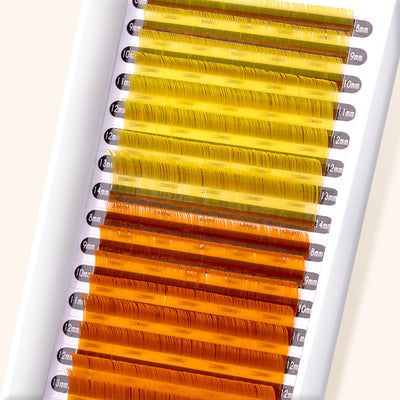 close up of yellow and orange colored lashes. 8 rows are bright yellow, and 8 rows are bright orange.