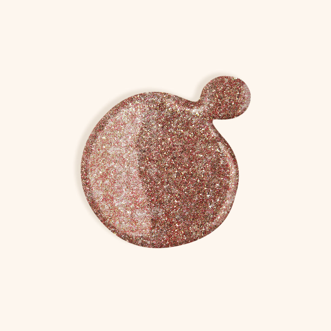 Rose gold glitter gel nail polish in the bottle