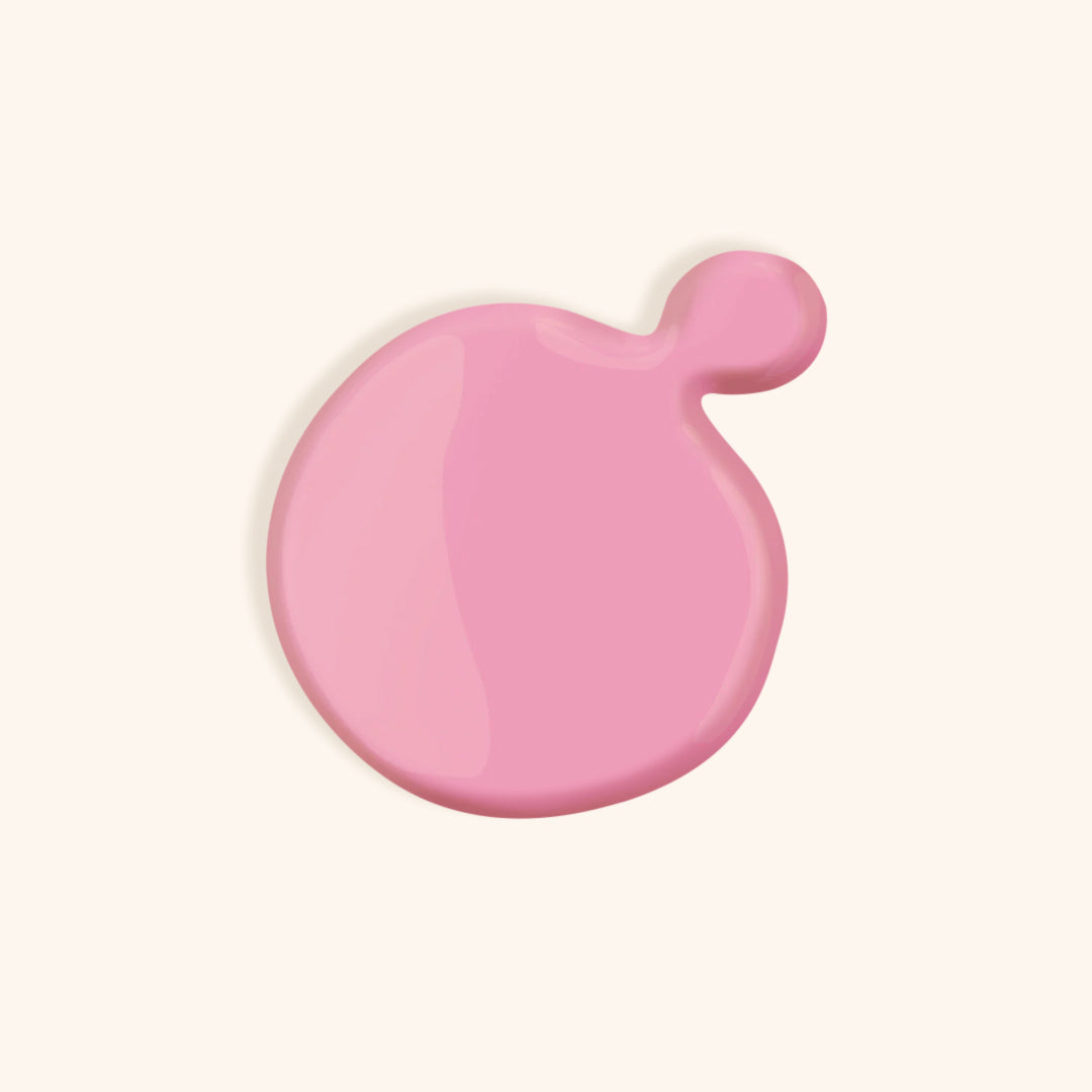 Pink nail polish in front of a beige background