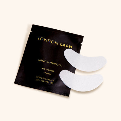 a pair of nano-hydrogel eye patches next to their packaging
