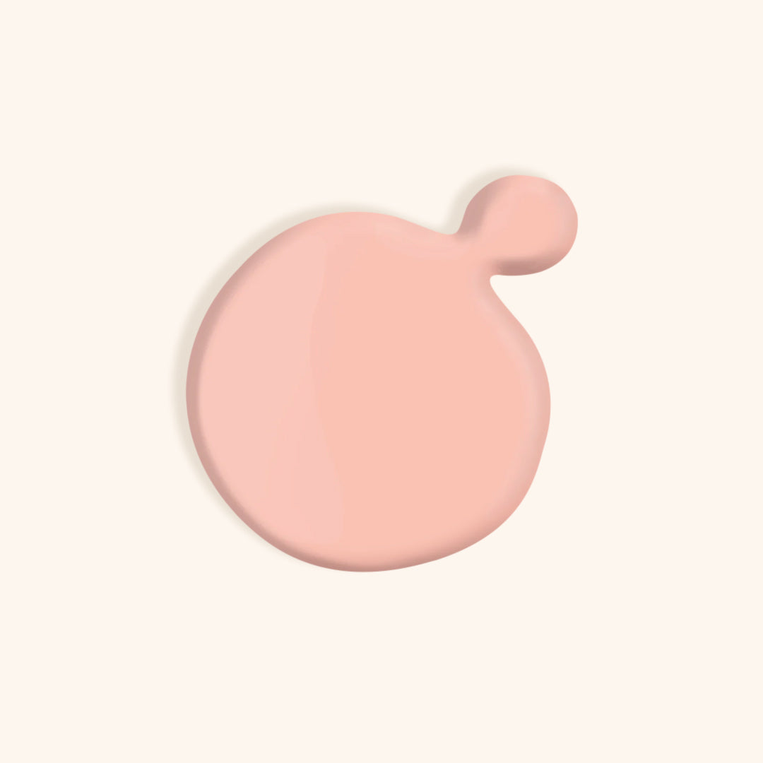 Light pastel pink nail polish in front of a beige background