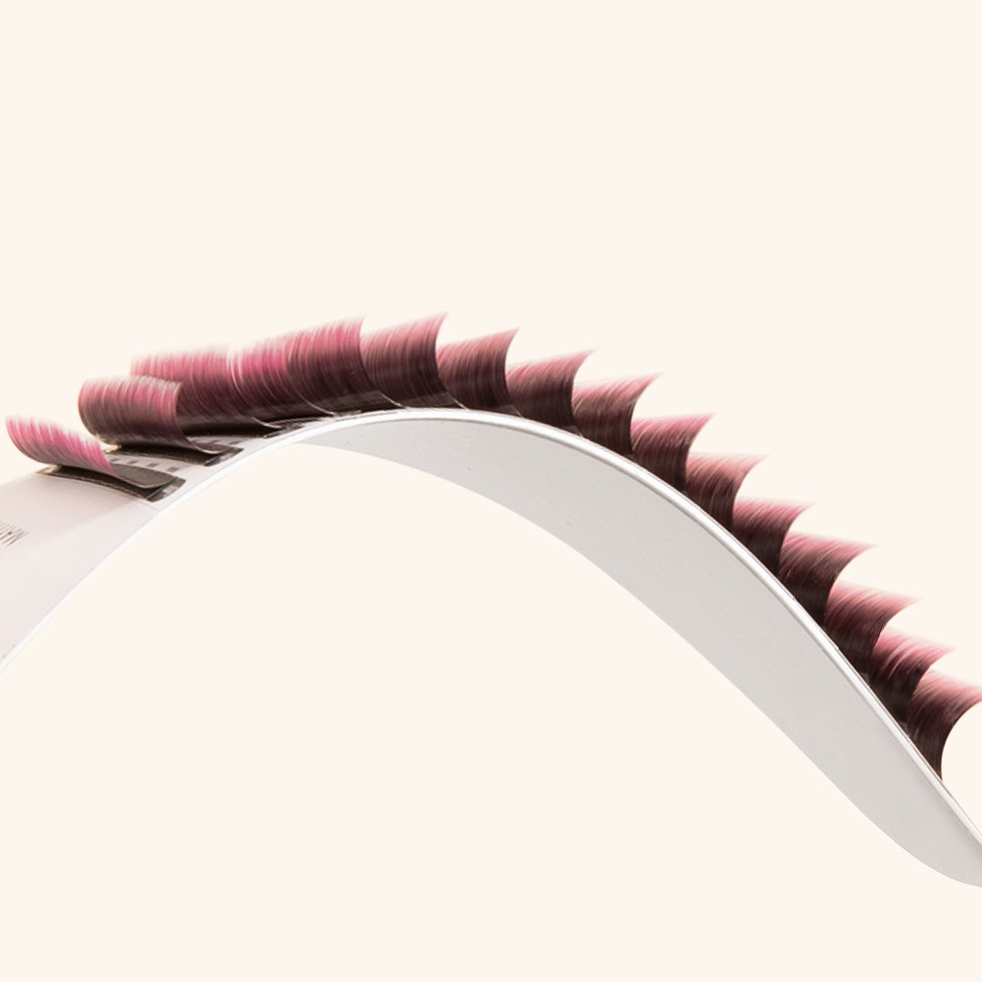 a side-on view of ombre lashes showing their pink tips and their curl