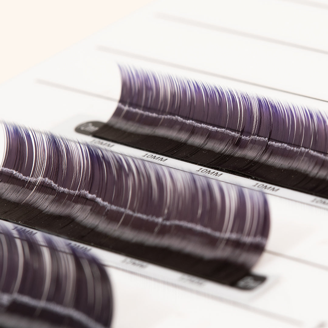 a close up of ombre lashes on a lash palette showing their purple tips