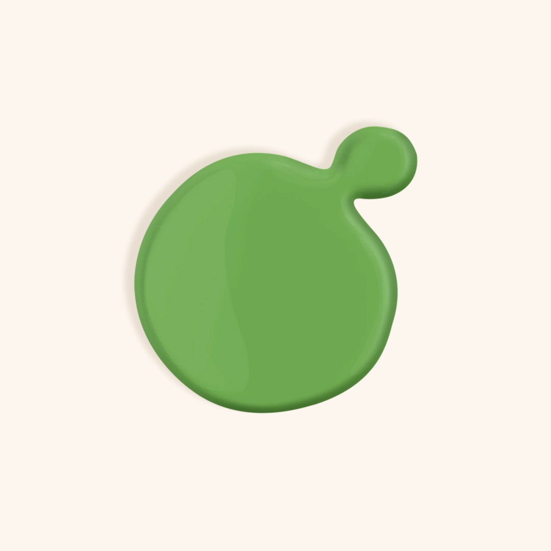 Pastel green gel nail polish in front of light background