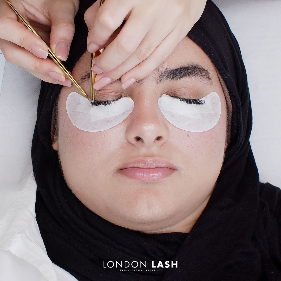 A client receiving lash extension training with London Lash, focused on lash extension training techniques and application.