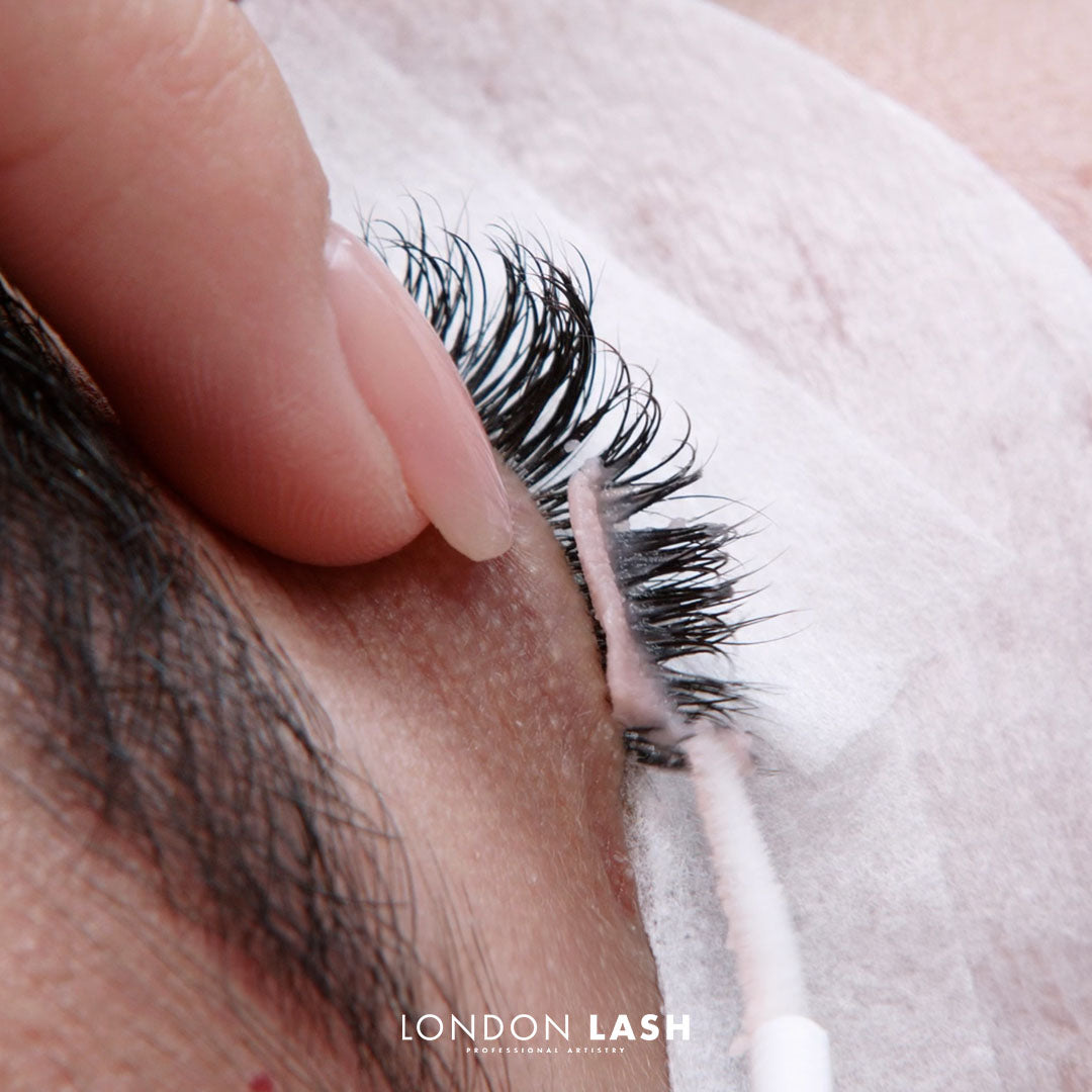 Applying eyelash extensions during lash extension training by London Lash.