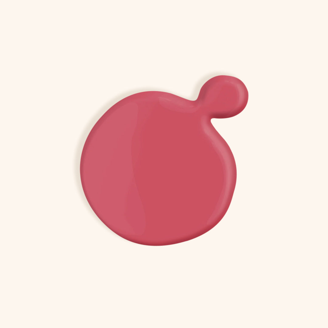 Summer pink nail polish in front of a beige background