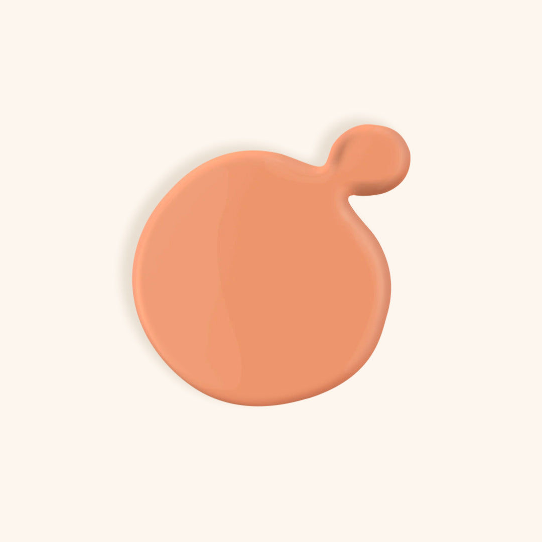 Pastel coral gel nail polish in a white bottle
