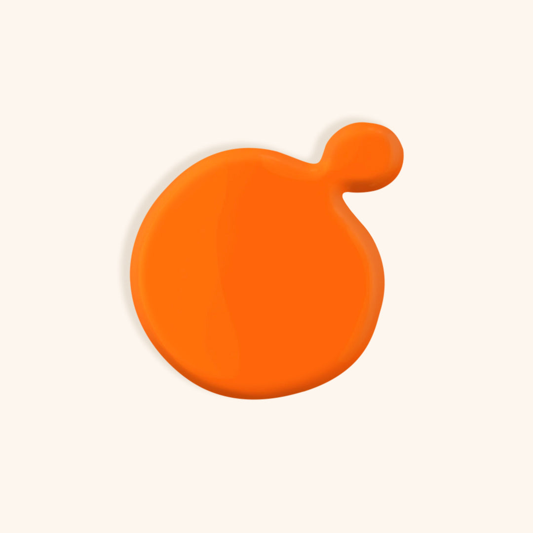 Bright orange gel nail polish color in front of a beige background