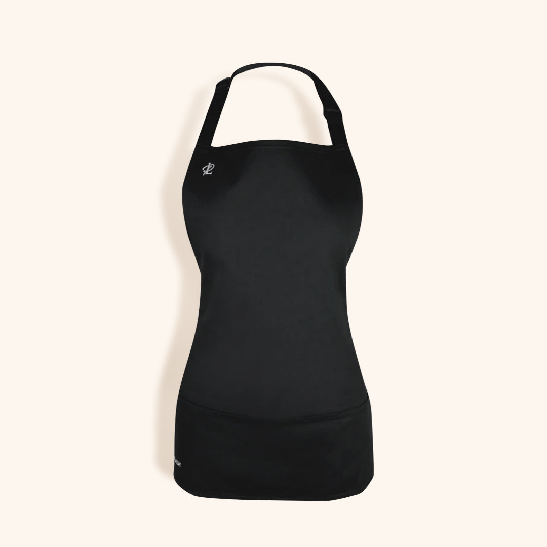 a simple black apron for lash techs, featuring a front pocket and a small london lash logo on the right breast