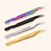a group of 4 angled isolation lash tweezers arranged in a line. the top pair is a rainbow design followed by black, silver, and finally gold