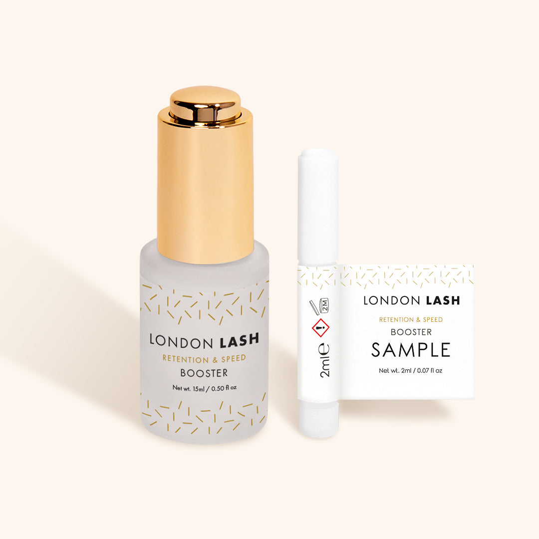 a glass bottle of a london lash booster next to a sample bottle 