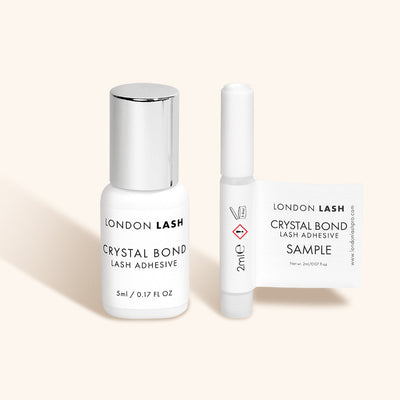 a sample bottle and a full-sized bottle of london lash crystal bond clear lash glue