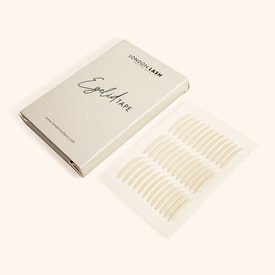 a box of eyelid tape next to a sheet of 36 strips