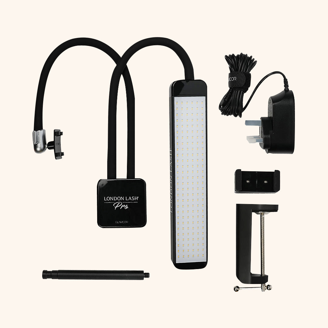 a flat lay of the glamcor capture showing the light with its phone attachment, the clamp attachment, plug and phone holder