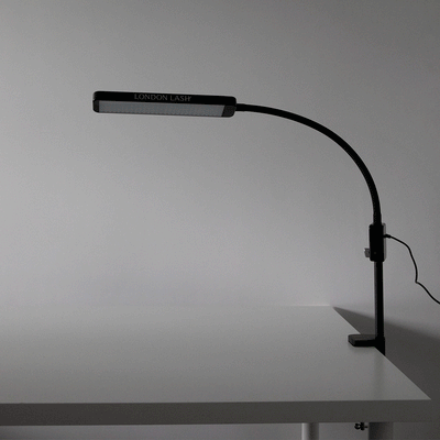 a glamcor light attached to a table. this is a gif showing the five dimming stages of a glamcor light
