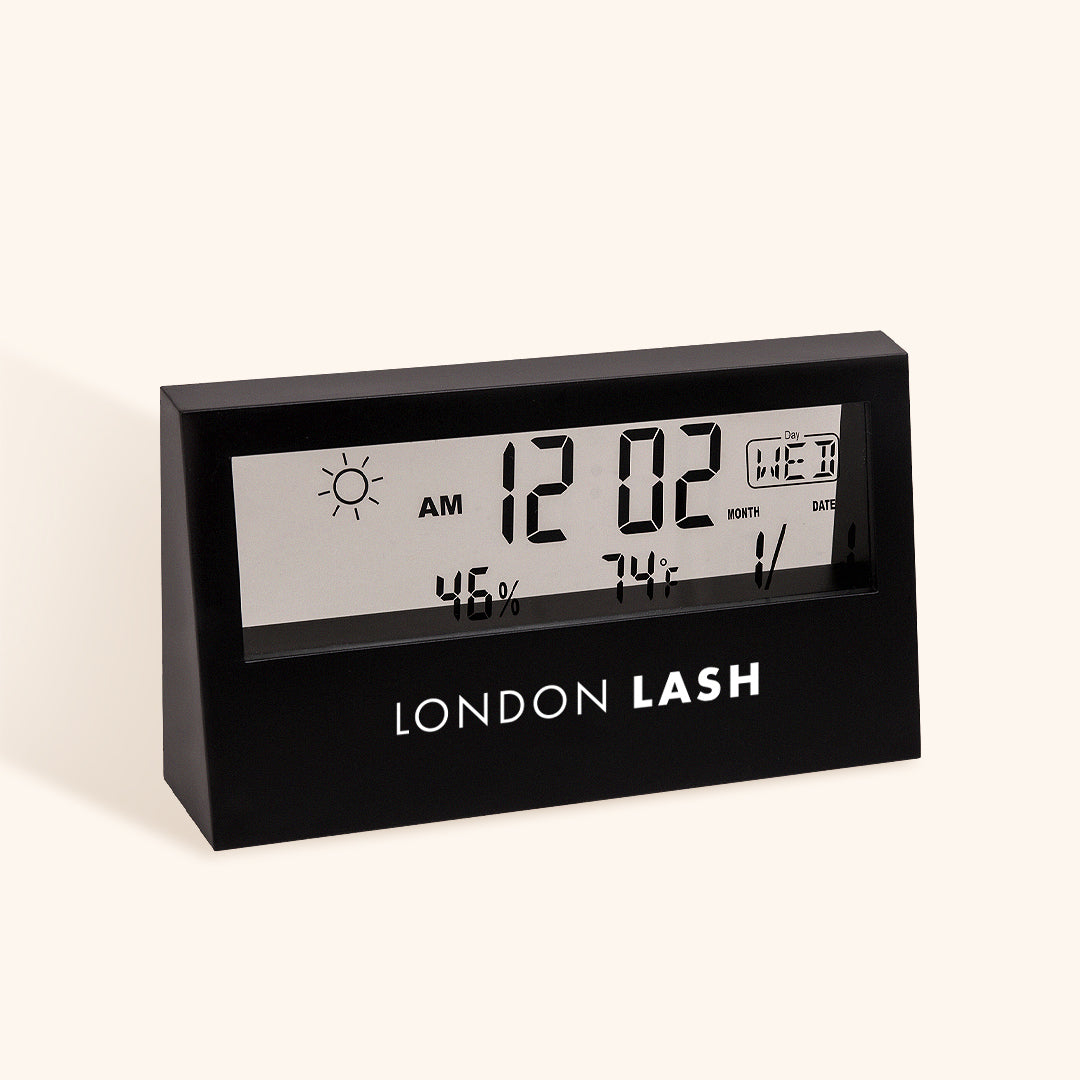 a matt black hygrometer with a transparent screen featuring black digital information