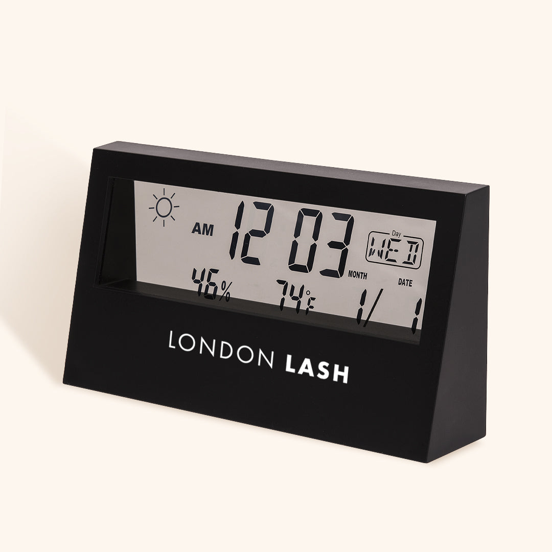 a matt black hygrometer with a transparent screen featuring black digital information