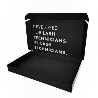 A box for lash extension kits. The lid is open and the text on the inside reads 'developed by lash technicians for lash technicians'