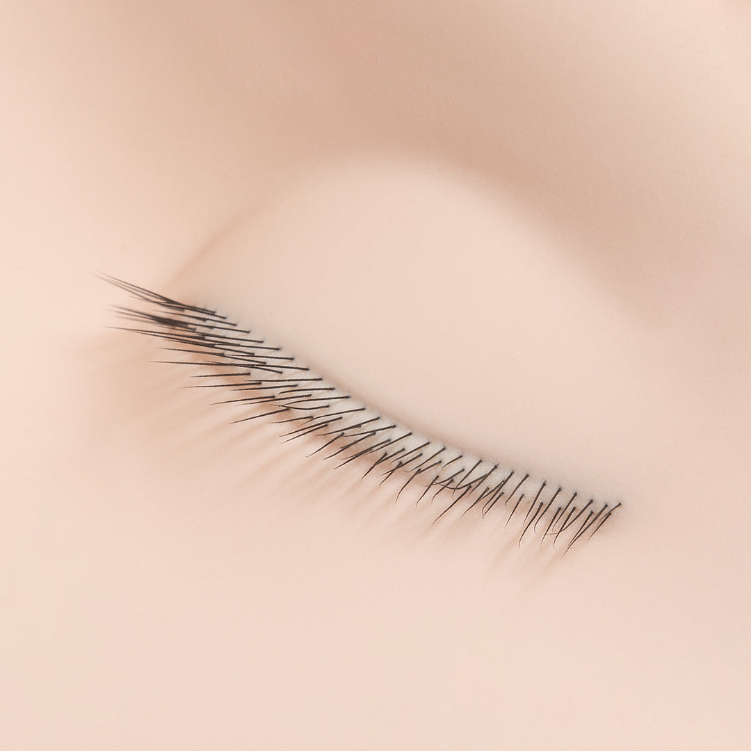 a close up of the lashes on a mannequin training head for lash extensions