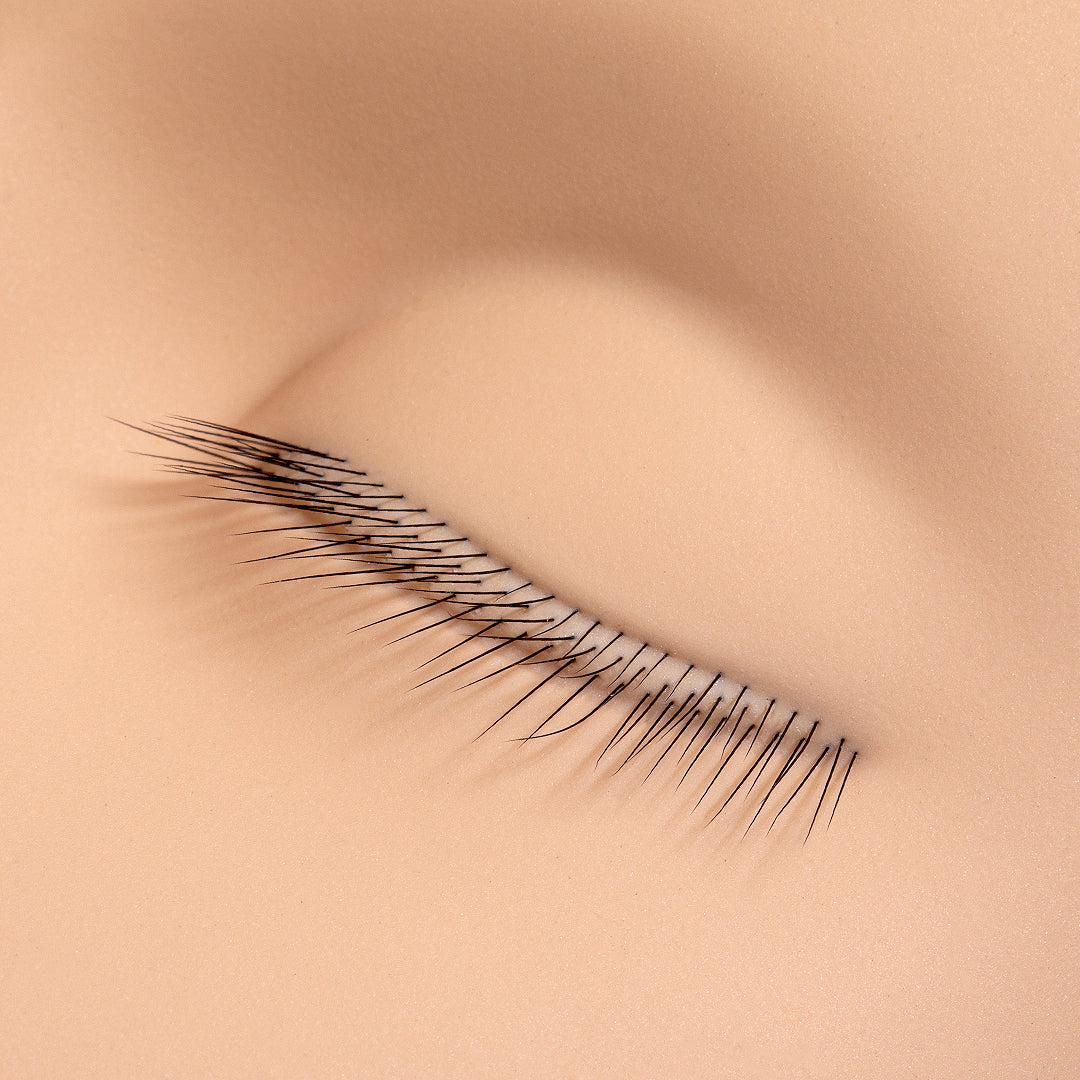 a close up of the lashes on a mannequin training head for lash extensions