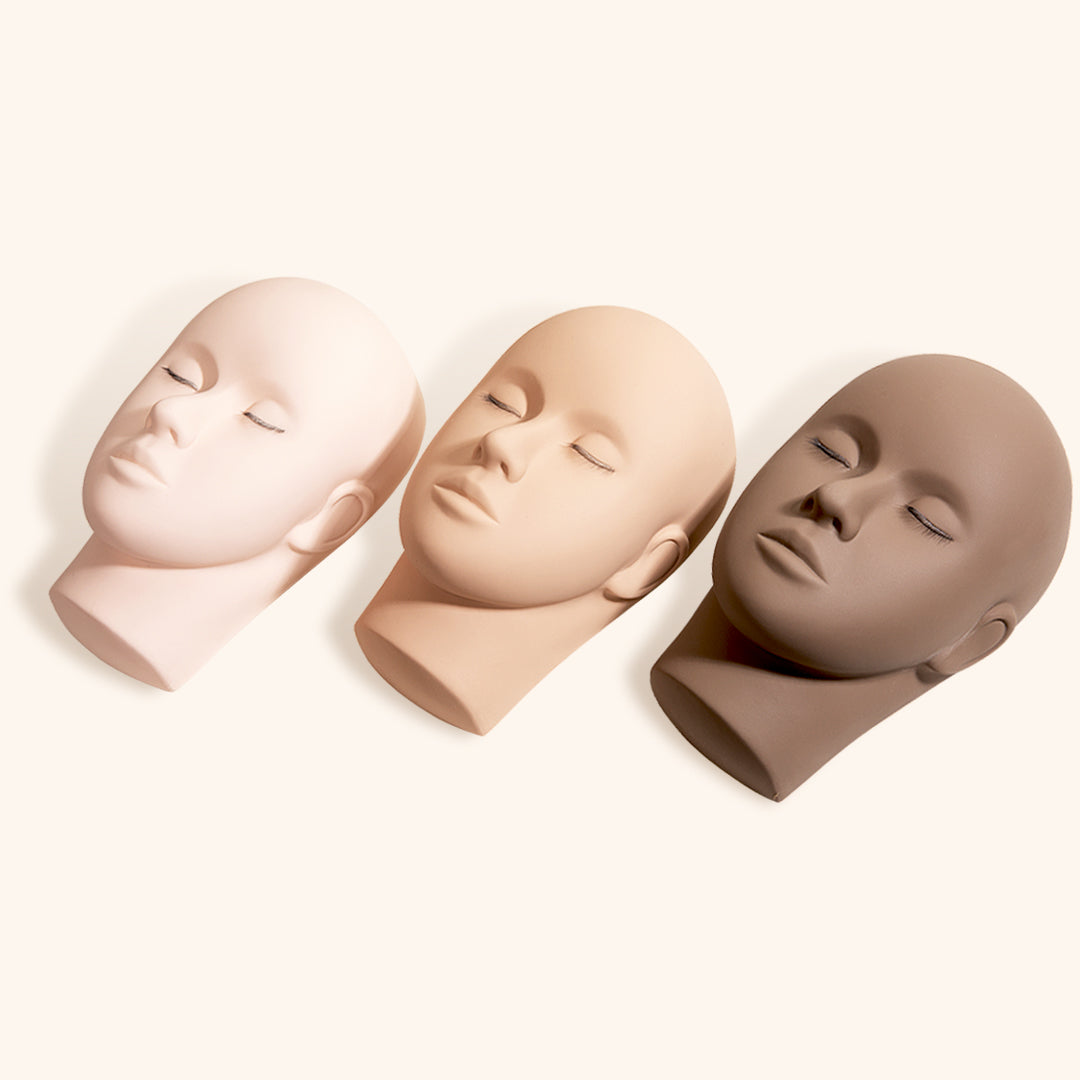 three mannequin training heads for lash extensions side by side in a line showing different &#39;skin&#39; colors