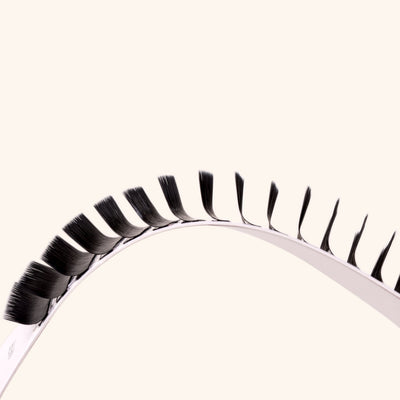 a mayfair lash card held on a curve to show the m curl lashes from the side