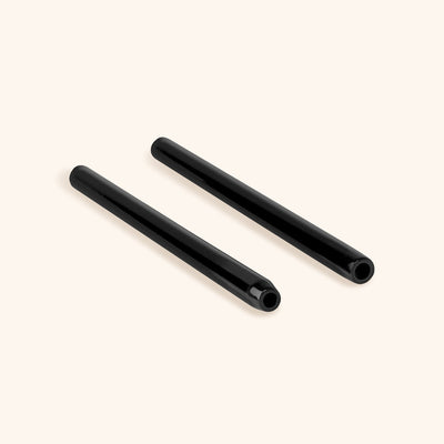 two reusable metal handles for mascara wands laying side by side