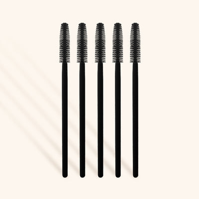 a row of five silicone mascara wands for brushing lash extensions
