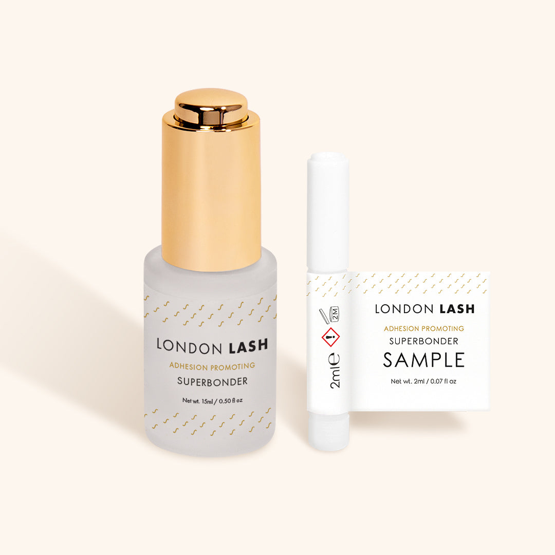 a full-sized bottle of london lash superbonder lash glue sealant beside a sample-sized bottle