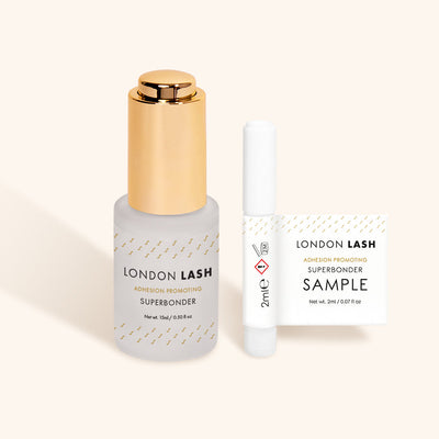 a full-sized bottle of london lash superbonder lash glue sealant beside a sample-sized bottle